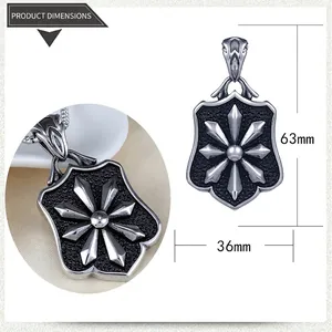 Macro detail of a 63mm x 36mm shield-shaped steel pendant with star and sandblasted texture