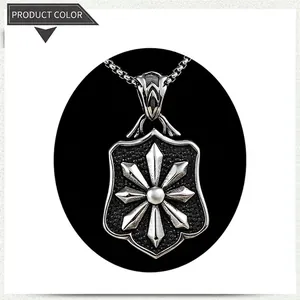 Detail of vintage shield pendant with embossed star on a stainless steel box chain