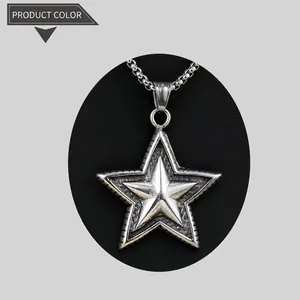 Detail view of silver star pendant with textured center and metal bead chain necklace