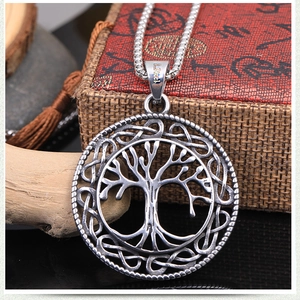 Detail of Tree of Life pendant with Celtic knot pattern on vintage jewelry box