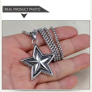 Detailed view of a vintage stainless steel five-point star pendant on a metal bead chain