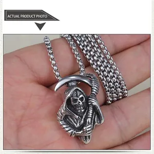 Detail of gothic grim reaper skull pendant in vintage silver steel with pearl chain