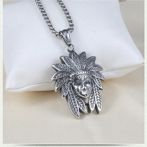 Detail of vintage steel Indian chieftain pendant with feather headdress on square pearl chain