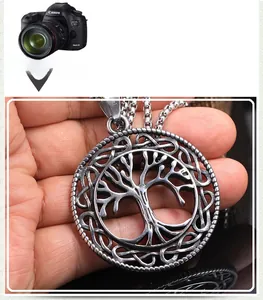 Macro detail of silver-tone stainless steel Tree of Life pendant with Celtic knot edge