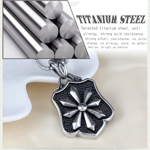 Vintage titanium steel shield pendant necklace with starburst design on ceramic tray