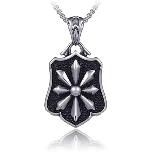 Vintage stainless steel shield pendant necklace with starburst design on white background
