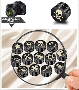 Macro view of assorted black magnetic stud earrings featuring skull and star patterns