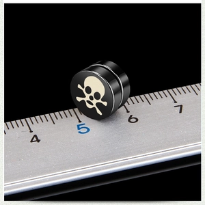 Macro shot of black magnetic skull earring showing precise 1cm diameter scale measurements