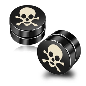 Macro shot of black magnetic punk stud earrings with ivory skull and crossbones graphic