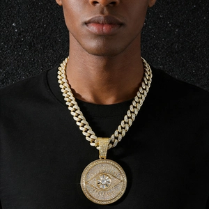 Gold iced out hip hop necklace featuring a cuban link chain and devil eye round pendant