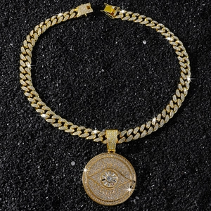 Macro shot of hip hop pendant with sparkling crystals and gold cuban link chain