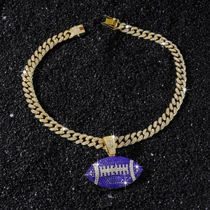 Detailed macro of gold-plated iced-out Cuban chain and dark blue football pendant
