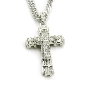 Macro shot of silver hip-hop cross pendant set with sparkling white rhinestones