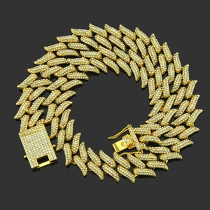 Close-up of gold iced out Cuban chain necklace with sparkling micro-pave crystals