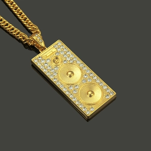 Hip hop speaker pendant necklace with gold plating and cubic zirconia on black mirror
