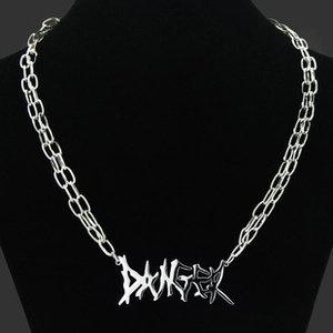 Close-up of silver DANGER pendant on a punk-style interlocking double ring link chain
