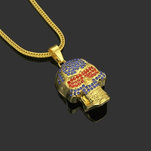 Macro shot of hip hop skull pendant with red and blue crystals on Franco chain