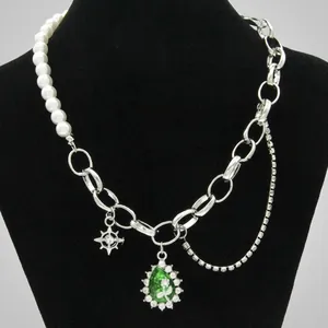 Detail of a pearl and silver chain necklace featuring an octagonal star and teardrop pendant