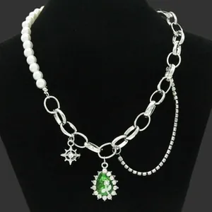 Detail of a pearl and silver chain necklace featuring an octagonal star and teardrop pendant