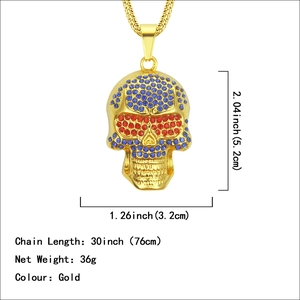 Gold skull pendant necklace with blue crystals and dimensions of 5.2cm by 3.2cm