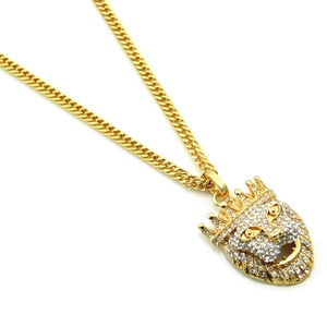 Close-up of hip hop crown lion head pendant with sparkling rhinestones on golden cuban chain