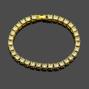 Close-up of golden tennis bracelet with round cubic zirconia in claw setting