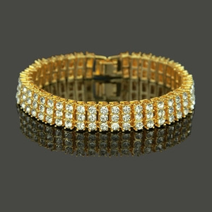 Macro shot of gold iced-out hip hop bracelet featuring three rows of shining cubic zirconia