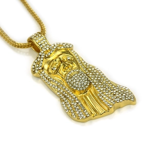 Close-up of gold hip hop Jesus piece pendant with micro-pave white crystals
