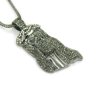 Macro shot of hip hop Jesus head pendant with black rhinestones and thick metal chain