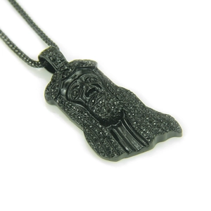 Detailed close-up of a black iced-out Jesus piece pendant necklace with micro pave stones