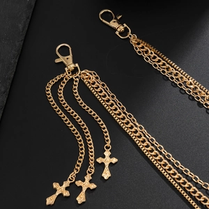 Détail de la chaîne multicouche dorée hip-hop avec pendentifs croix et mousquetons