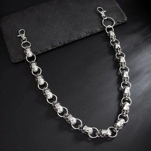 Punk style silver skull wallet chain for men with lobster clasps on stone background