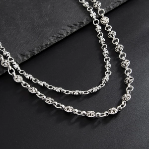 Close-up of gothic silver cross flower link chain with oxidized vintage finish