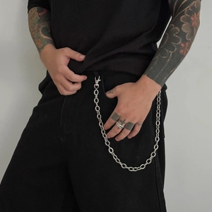 Close-up of vintage silver O-ring pants chain with metal lobster clasp on black jeans