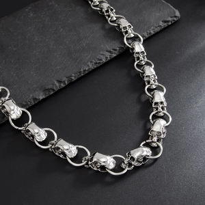 Close-up of hip-hop skull trouser chain with polished silver metal links on stone