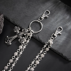 Detail of gothic metal pants chain with engraved cross charms and lobster clasps