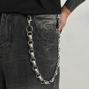 Punk style silver skull trouser chain with dual metal clasps on black denim jeans