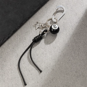 Détail du fermoir mousqueton avec étoile et pendentif de billard boule 8 noire tendance