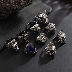 Detail of vintage punk rings featuring lion and wolf heads with antique silver finish
