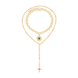 Gold layered Y-necklace with emerald sun pendant and cross bead chain on white background