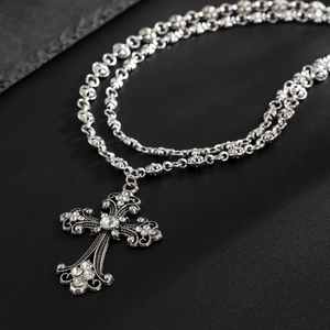 Gothic hip hop silver cross necklace with sparkling diamonds on a sleek black background