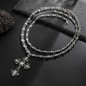 Gothic silver cross necklace with vintage carvings and white rhinestones on dark stone