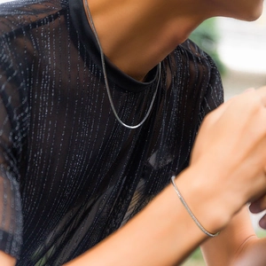 Minimalist silver snake chain necklace and bracelet set for men and women on model