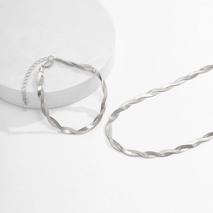 Close-up of silver braided snake chain set showing lobster clasp and texture