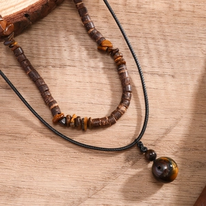 Men's necklace set featuring wooden beads and tiger eye stone on light wood surface