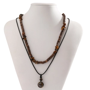 Close-up of double-layer necklace with brown wood beads and tiger eye stone pendant