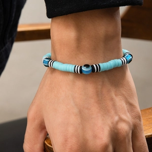 Men's bohemian evil eye bead bracelet with blue polymer clay discs and striped spacers