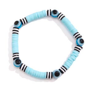 Close-up of blue Heishi beads and evil eye charms on elastic bohemian bracelet