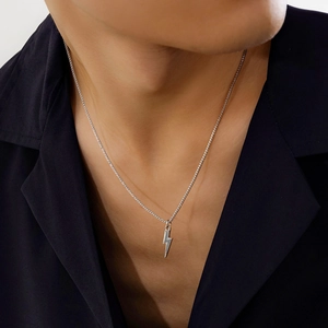 Minimalist silver lightning bolt pendant necklace with box chain for men worn on a model