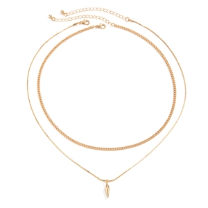 Detail of layered gold necklaces with punk spike pendant and snake chain texture